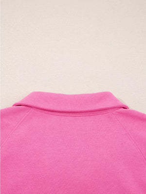 Hot pink collared pullover with raglan sleeves and a classic collar detail.