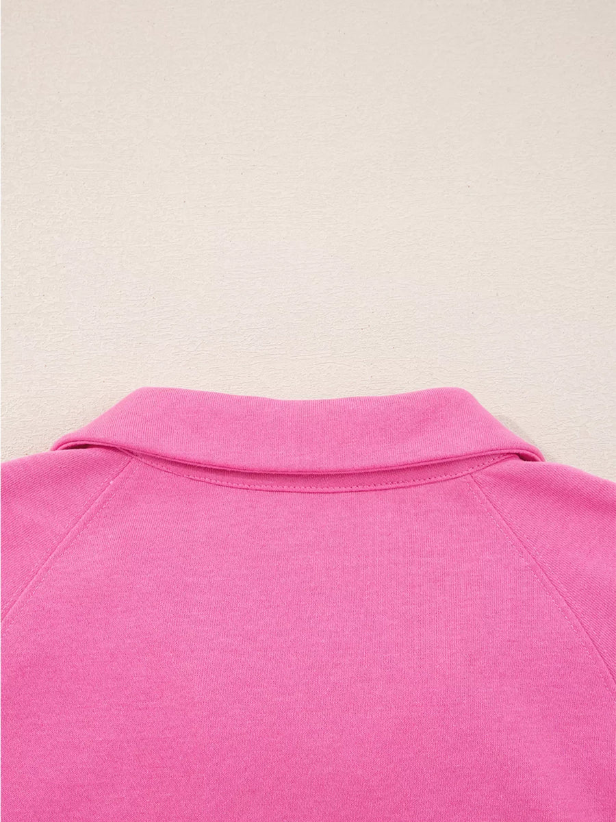 Hot pink collared pullover with raglan sleeves and a classic collar detail.
