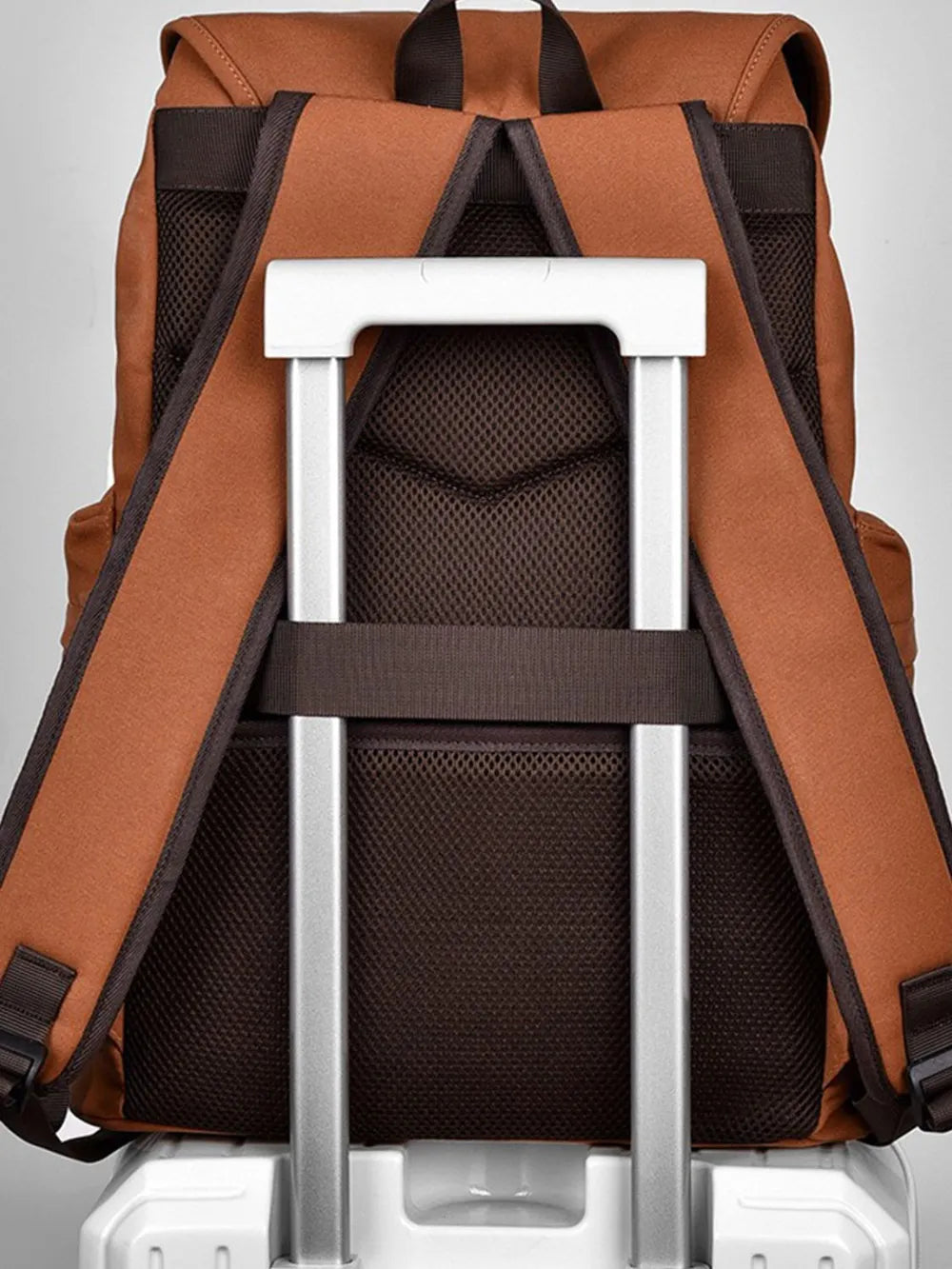 Ochre canvas backpack with luggage strap and mesh back panel.