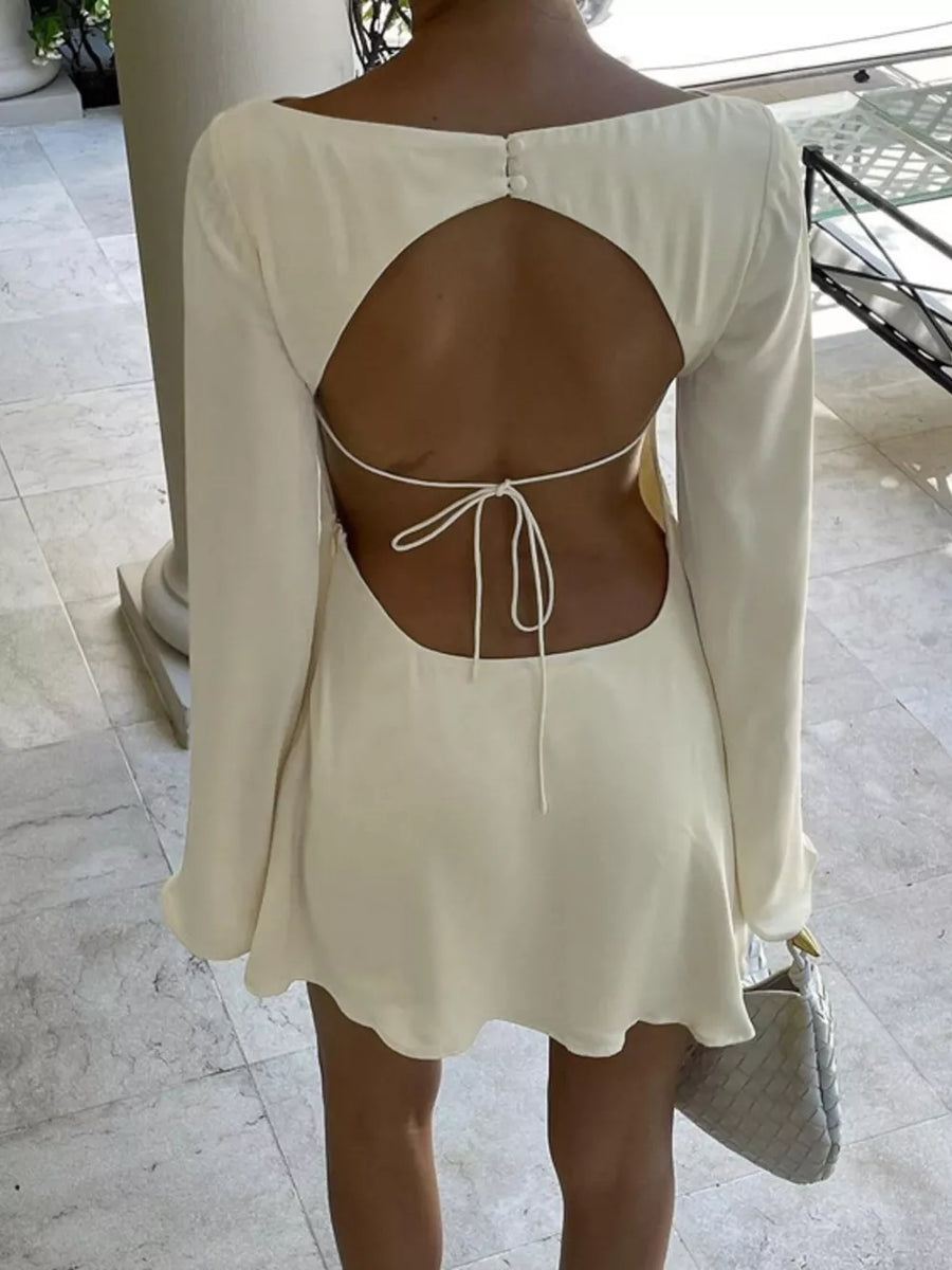 Cream long sleeve mini dress with open back and tie detail