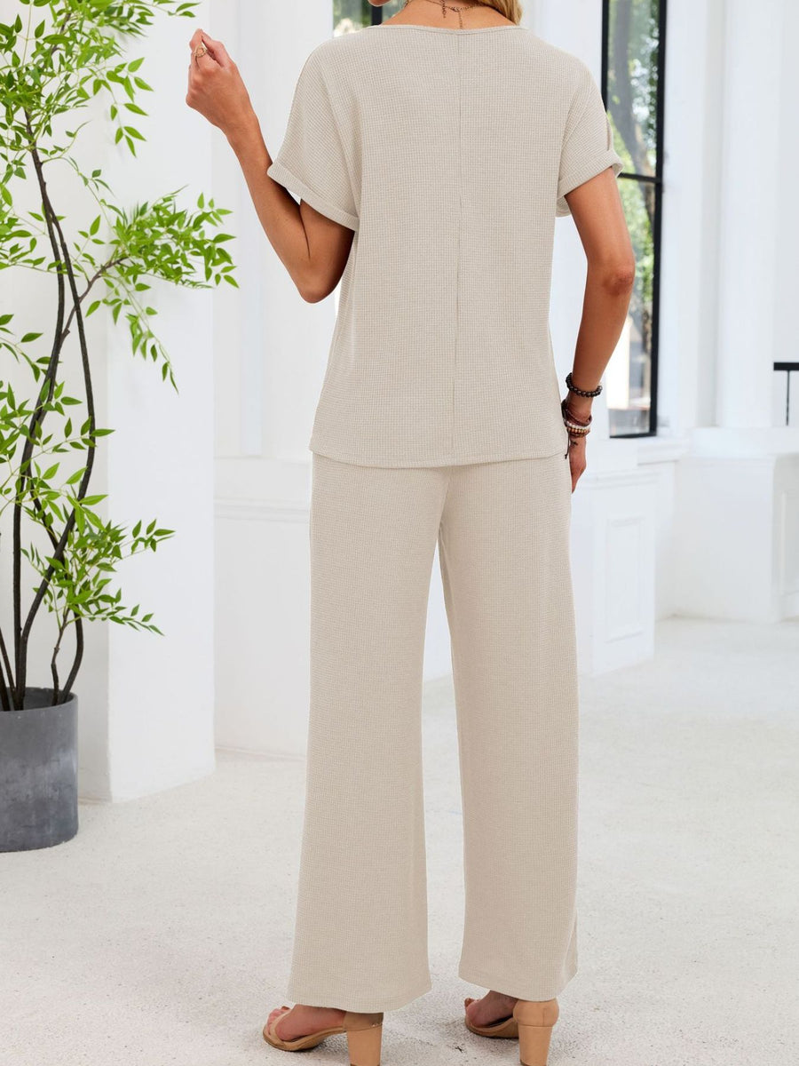 Beige waffle knit two-piece set with short sleeves and wide-leg pants.