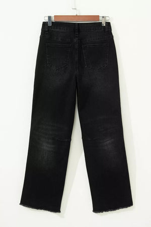 Black high-waisted cropped jeans with raw hem and distressed detail