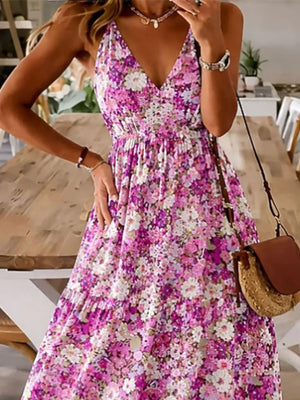 Floral tiered maxi dress with spaghetti straps in a vibrant pink and purple floral print.