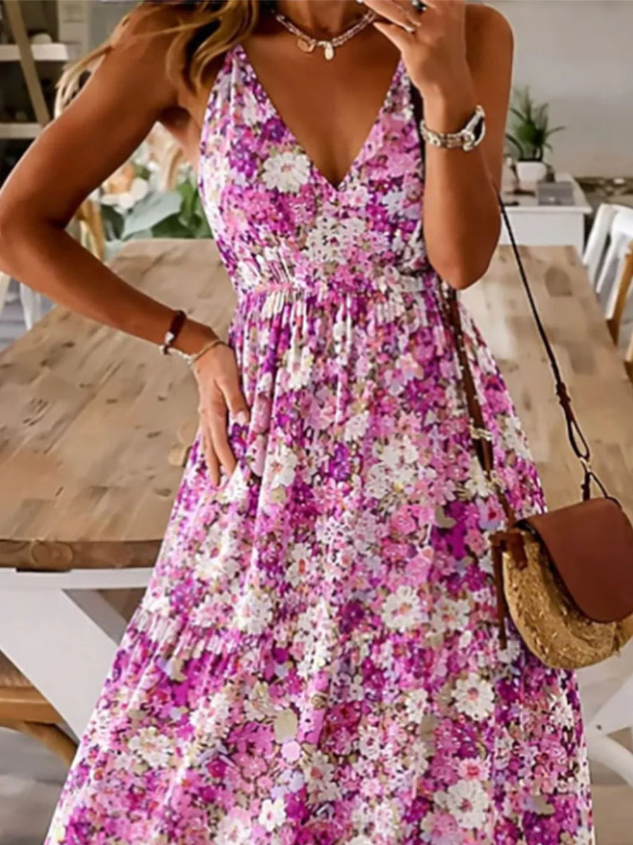 Floral tiered maxi dress with spaghetti straps in a vibrant pink and purple floral print.