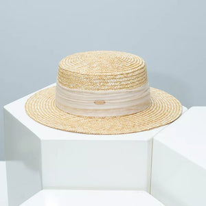 Beige straw boater hat with sheer ribbon band and oval logo detail