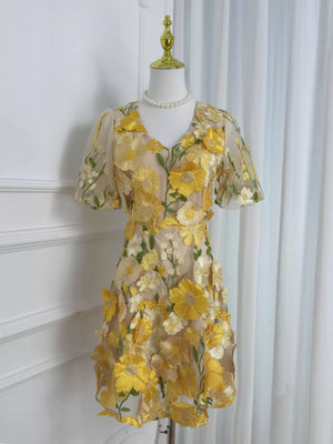 Sheer yellow floral embroidered short sleeve dress with V-neckline.