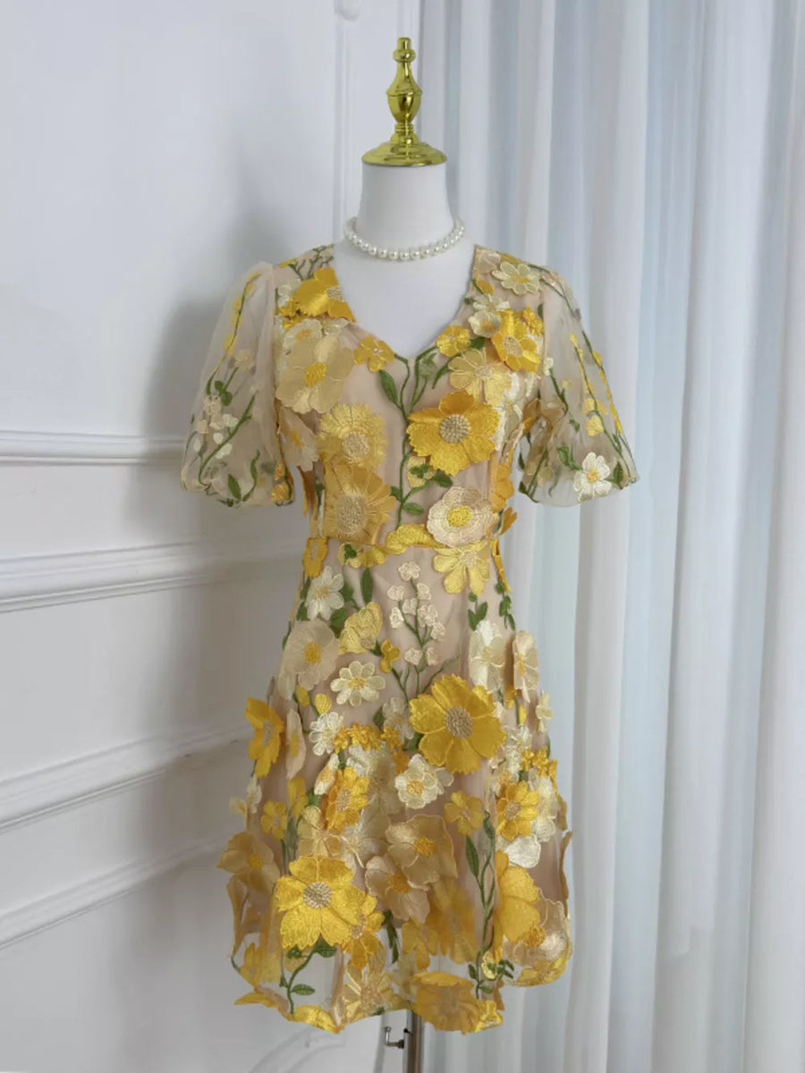 Sheer yellow floral embroidered short sleeve dress with V-neckline.