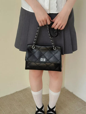 Black handbag featuring quilted and quilted