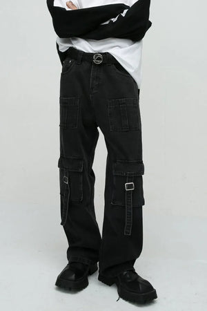 Dark utility denim cargo pants with buckle pockets and a statement belt.