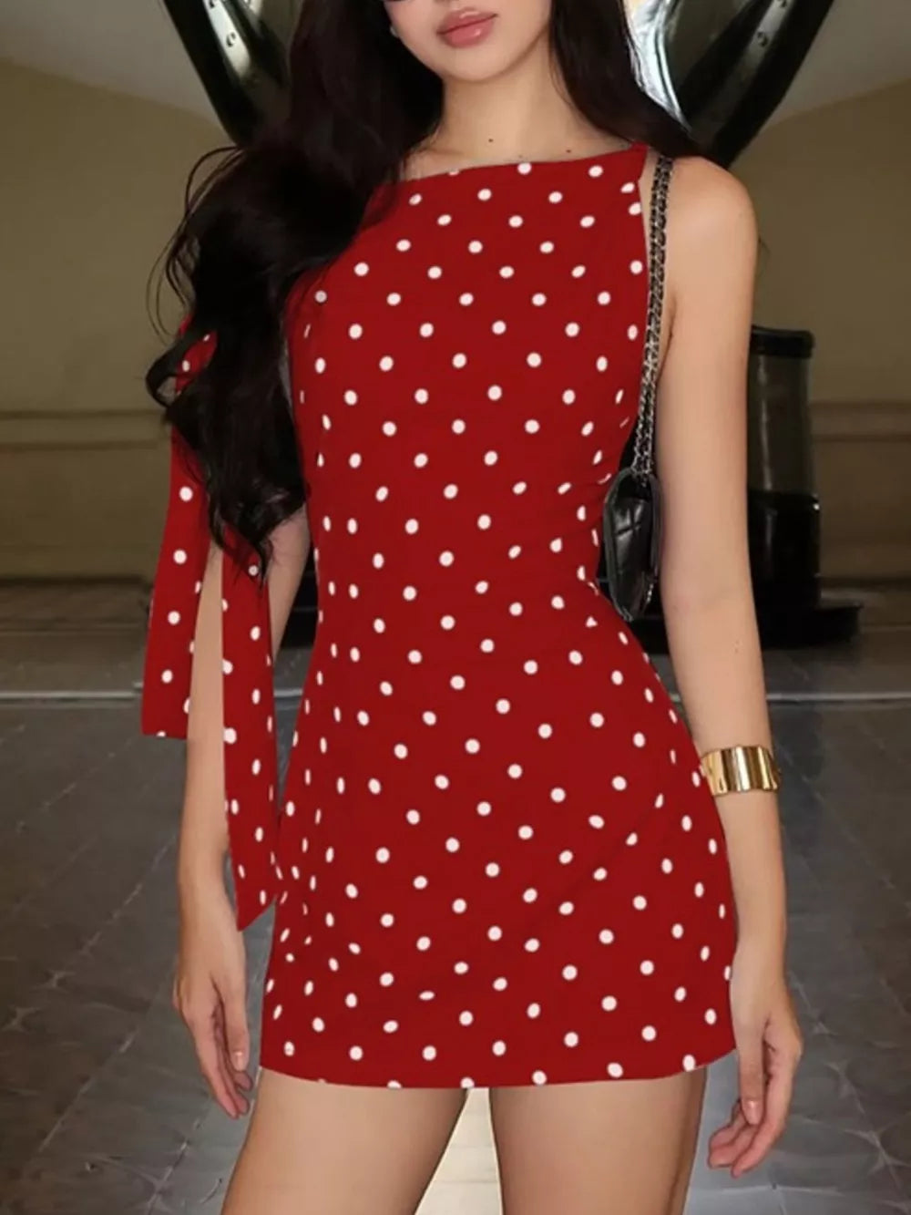 Red polka dot mini dress with asymmetrical bow detail on sleeve