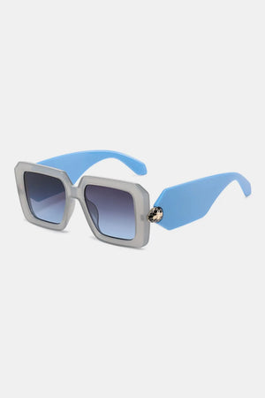 Geometric facet sunglasses in pastel blue with embellished detail and gradient lenses.