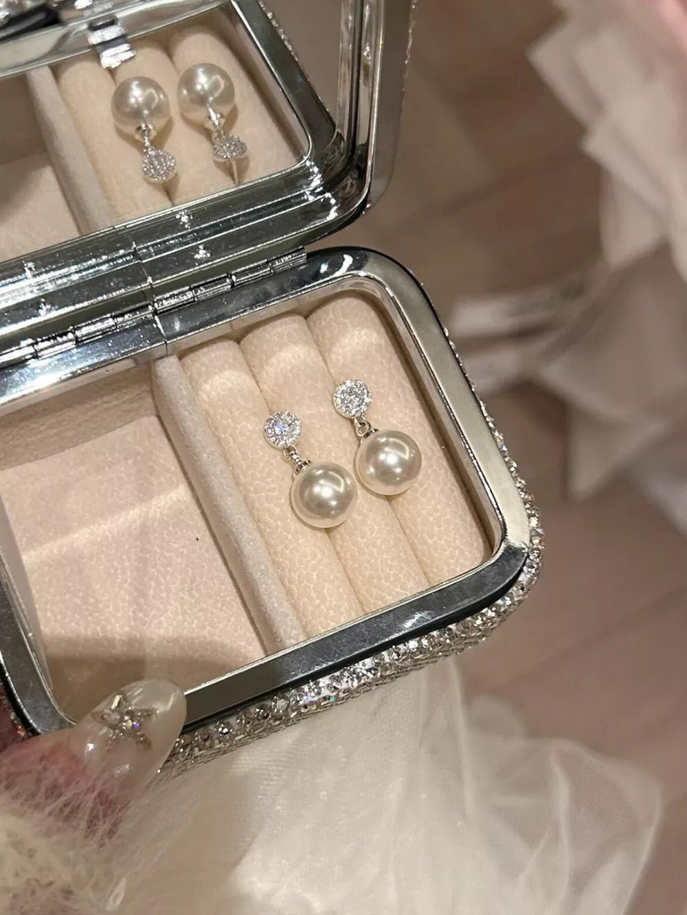 Lustrous pearl drop earrings with zircon accents on 925 silver.