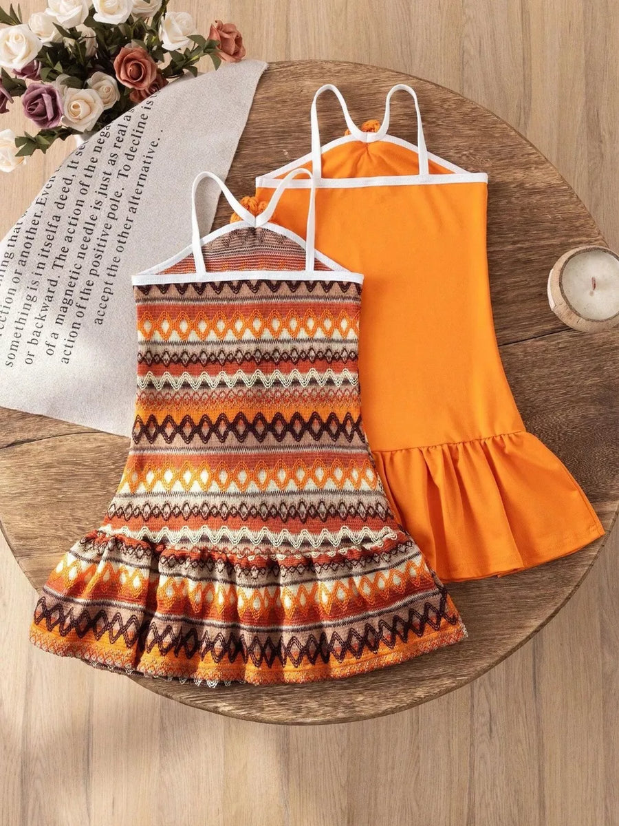 Baby halter dresses with ruffled hems, one orange, one with a geometric print.