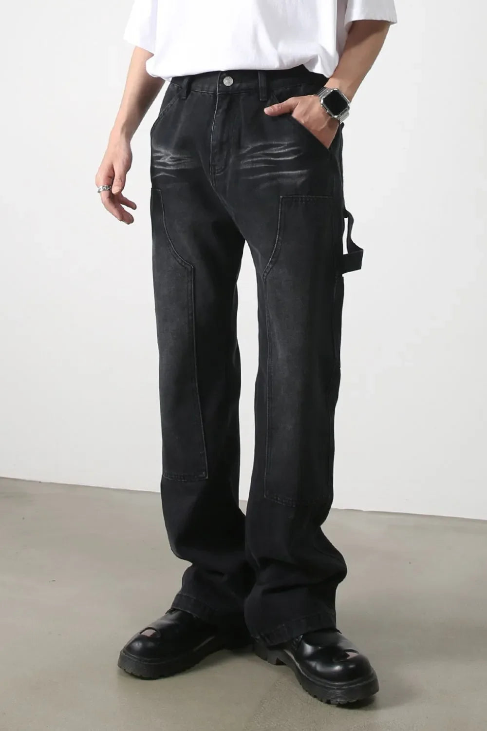 Dark wash denim wide leg carpenter jeans with utility loop and pocket details.