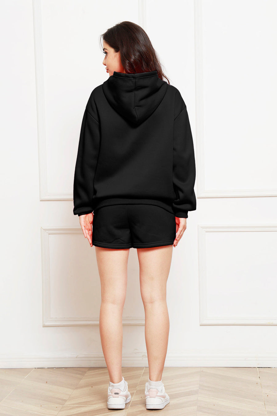 Black hooded loungewear set with shorts and a hoodie, shown from the back.