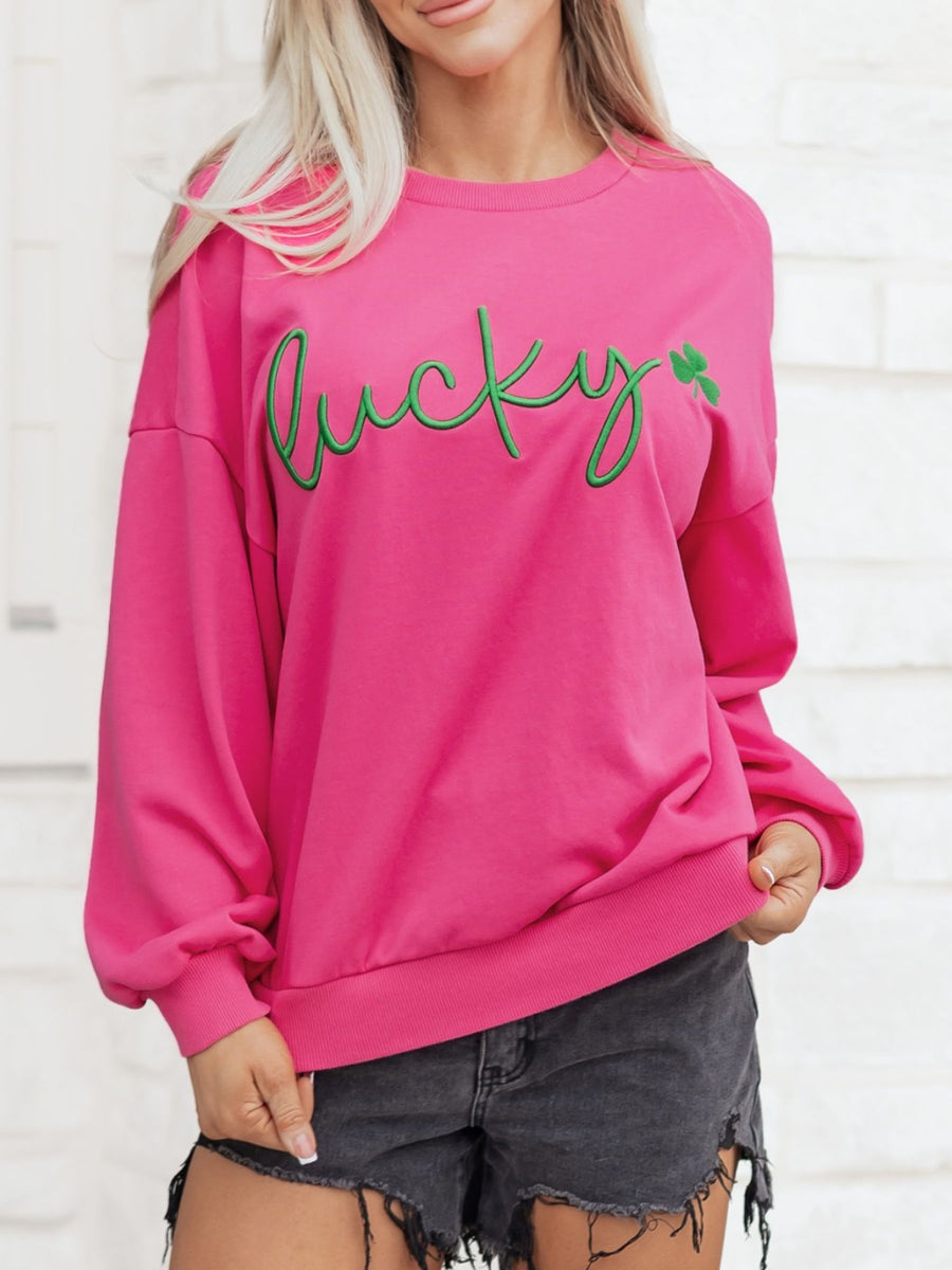 Pink crew neck cotton sweatshirt with green embroidered lucky clover graphic
