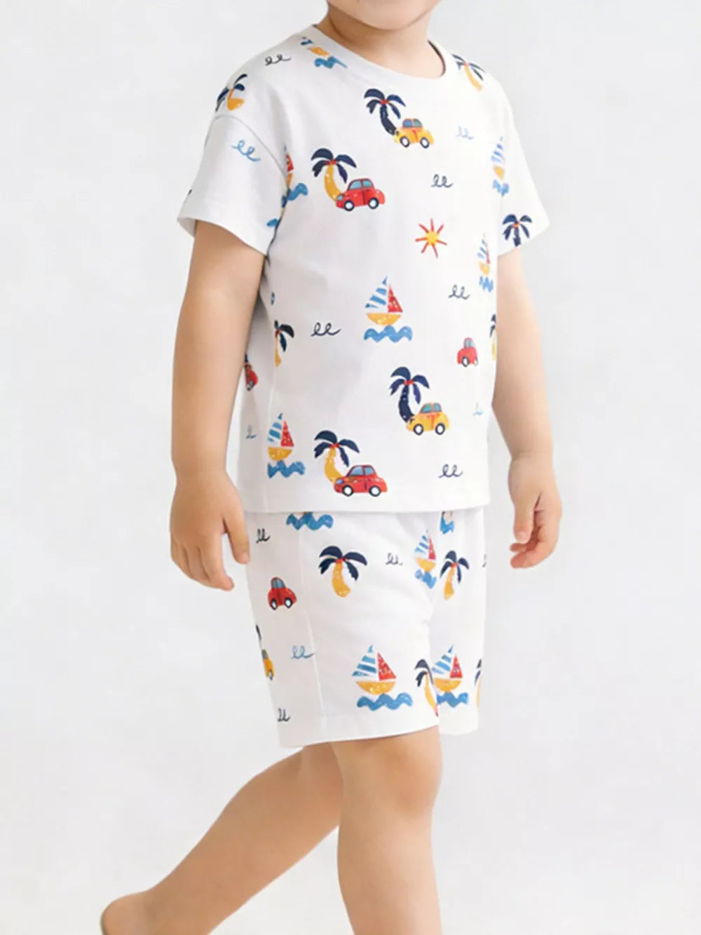 Boys' white cotton tee and shorts set with playful car, sailboat, and palm tree print.
