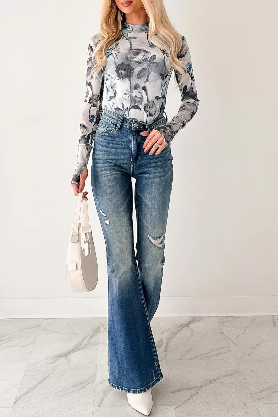 Sheer floral high neck long sleeve shirt with a grey and white floral pattern.
