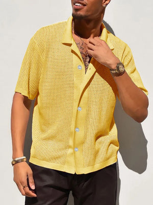Yellow perforated knit resort shirt with short sleeves and a collared neckline.