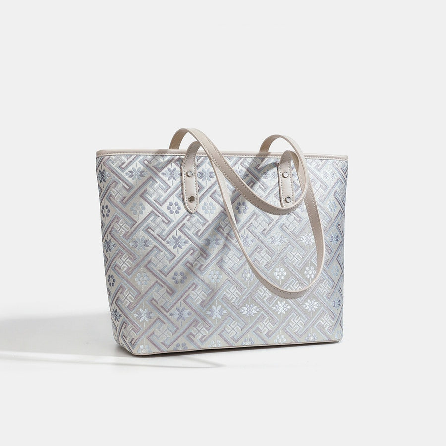 tote in pale lavender with geometric and tassel charm