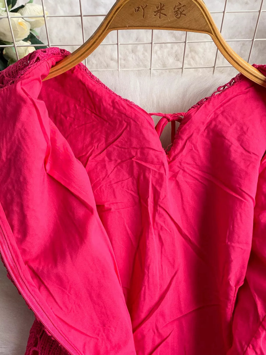 Fuchsia pink lace A-line dress with tie detail and cutout neckline.