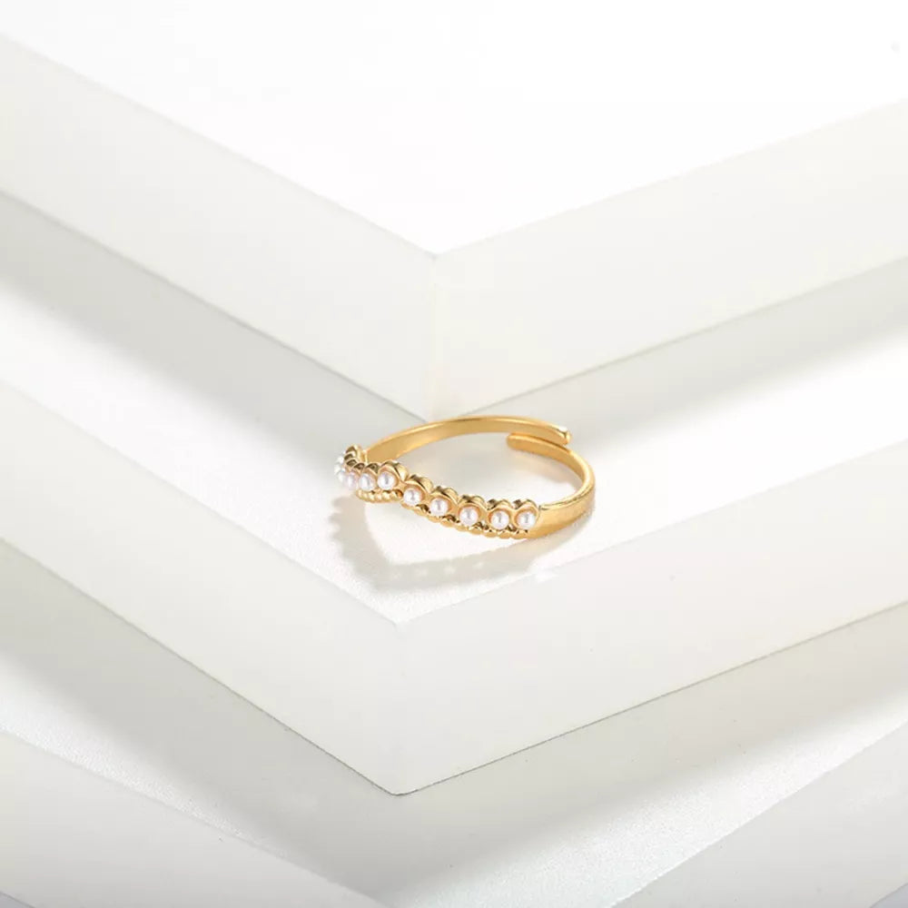 Gold adjustable ring with a row of small pearls.