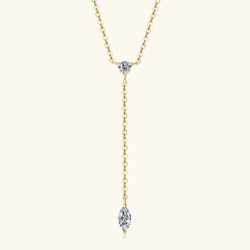 Gold lariat necklace with round and marquise moissanite pendants.