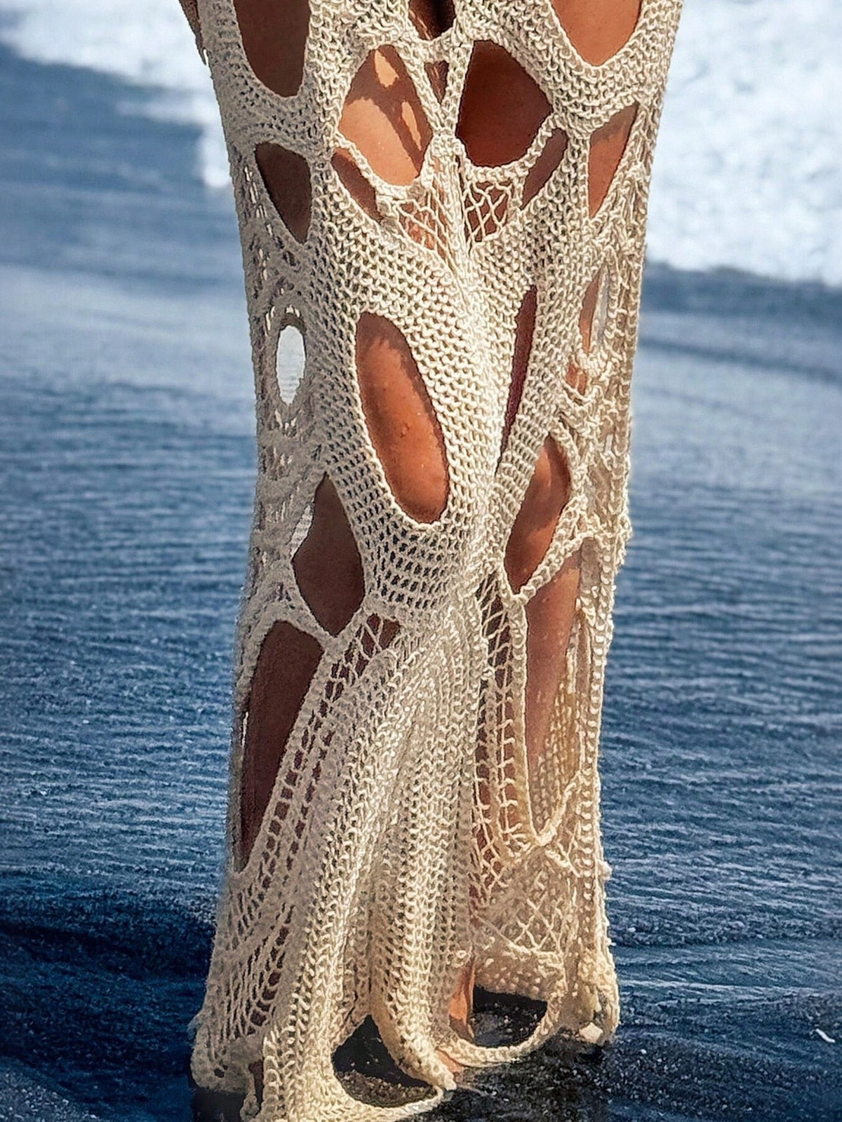 Cream crochet maxi dress with large cutouts and open knit detail.