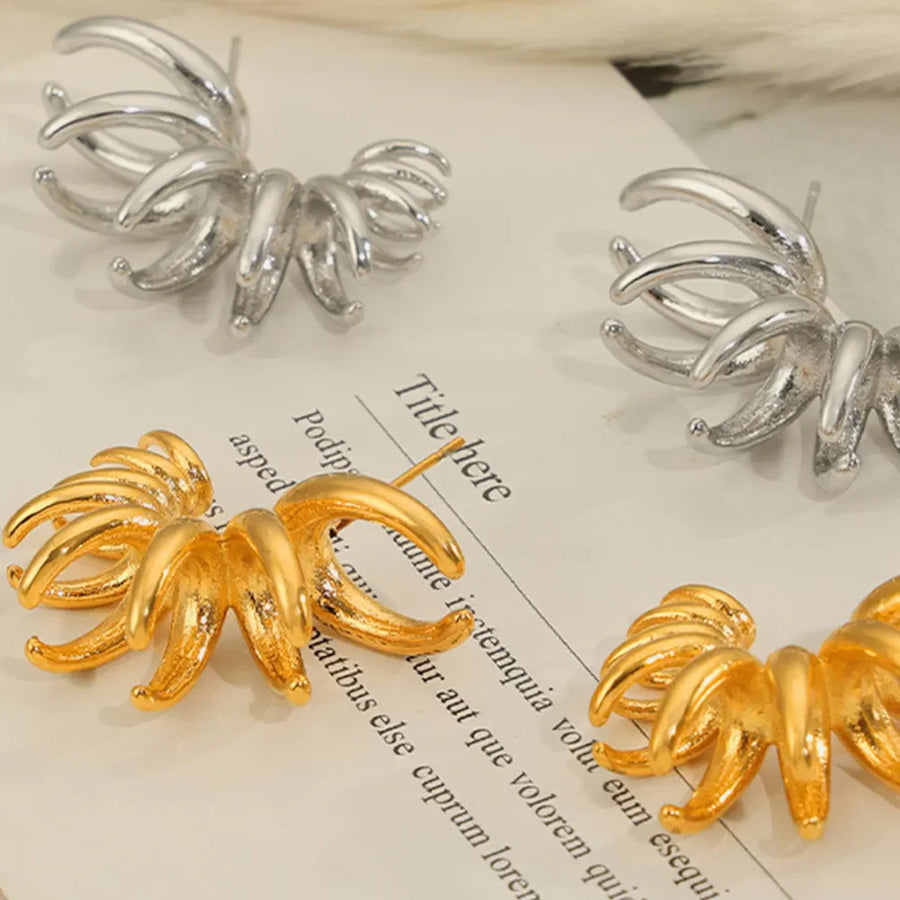 Sculptural petal drop earrings in gold and silver with a unique, curved design.