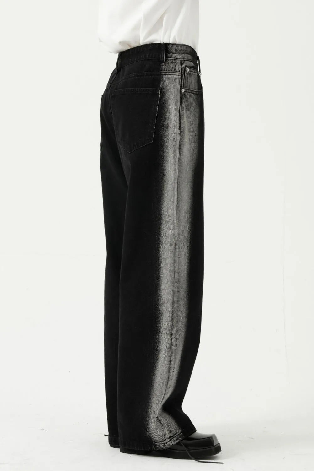 Dark wide leg jeans with faded side panels and a relaxed fit.