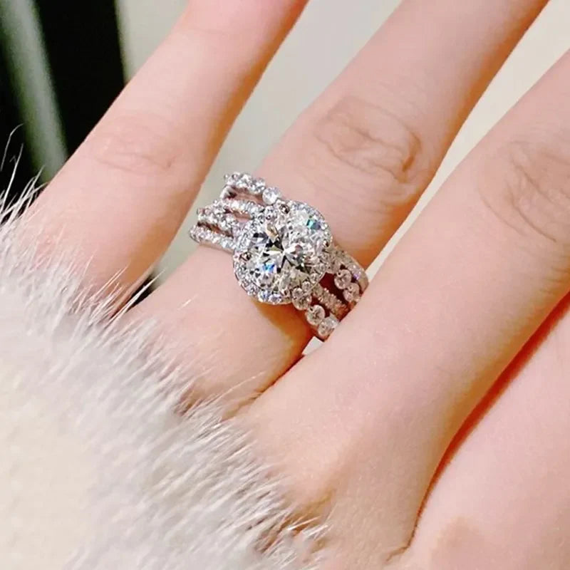 Silver triple band ring with oval moissanite halo and sparkling accents