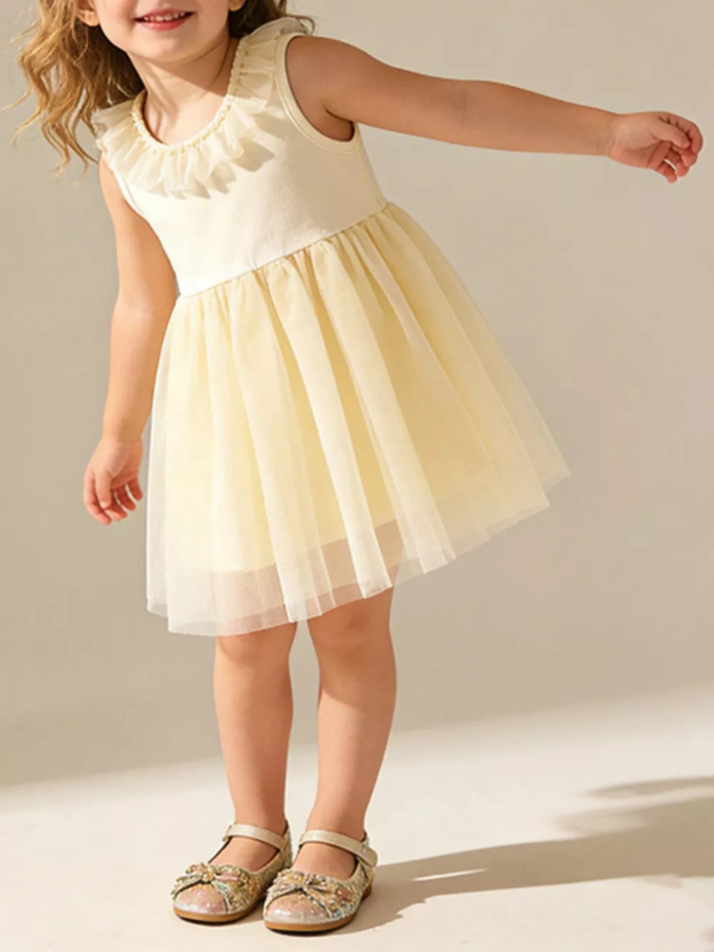 Baby girl's cream cotton dress with yellow tulle skirt and ruffled collar.