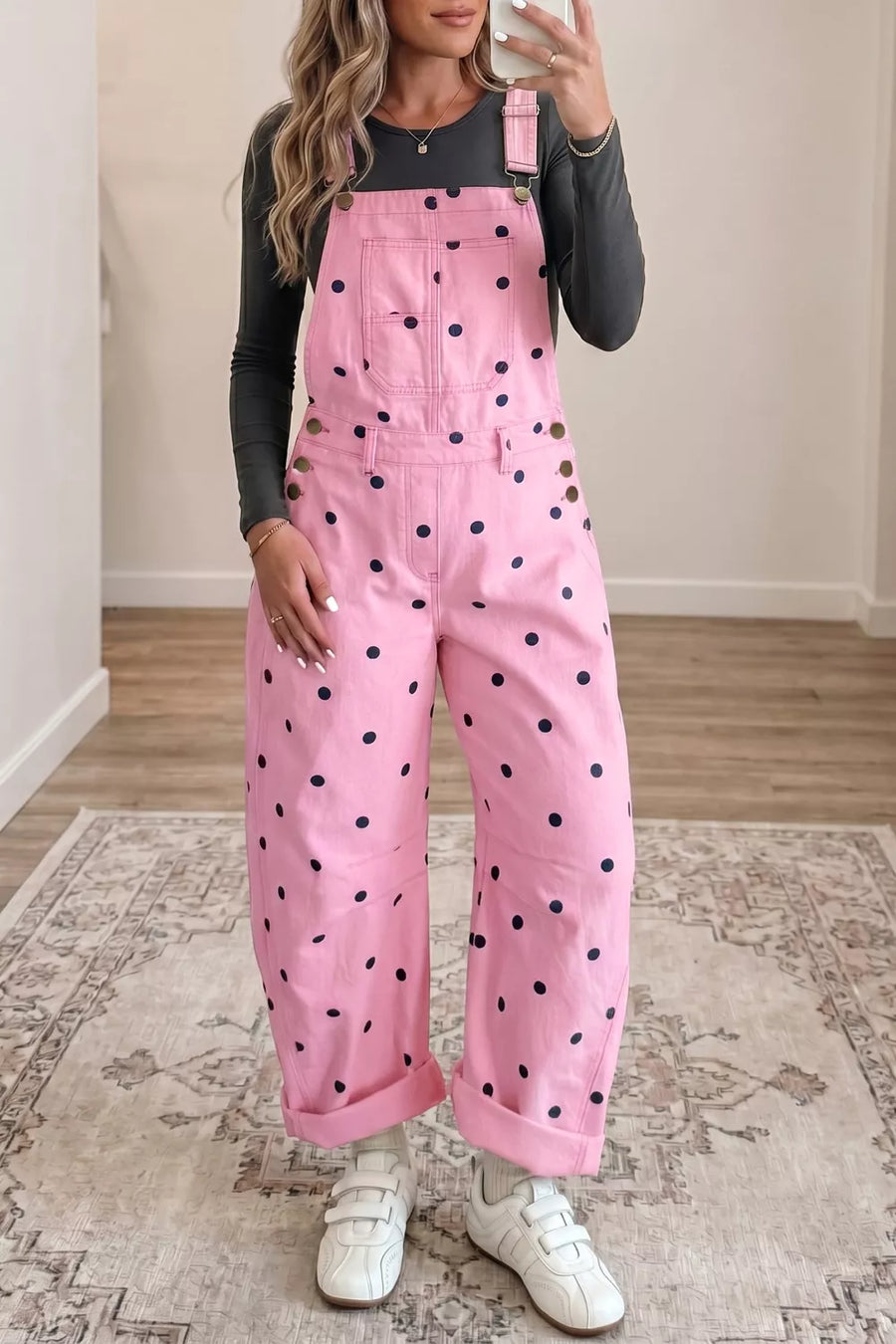 Pink denim overalls with navy polka dots, bib pocket, and buttoned sides.
