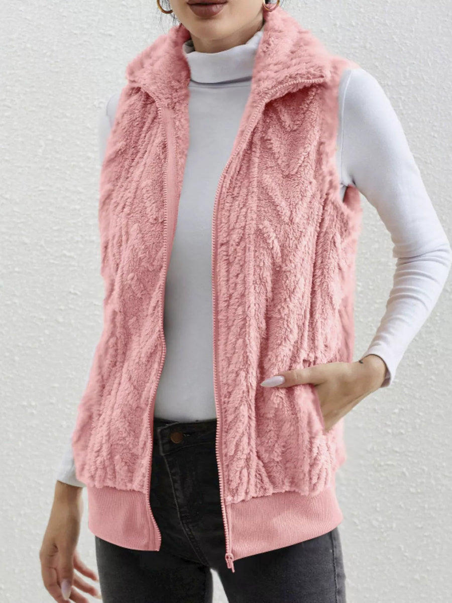 Pink faux fur zip-up vest with textured pattern and ribbed hem