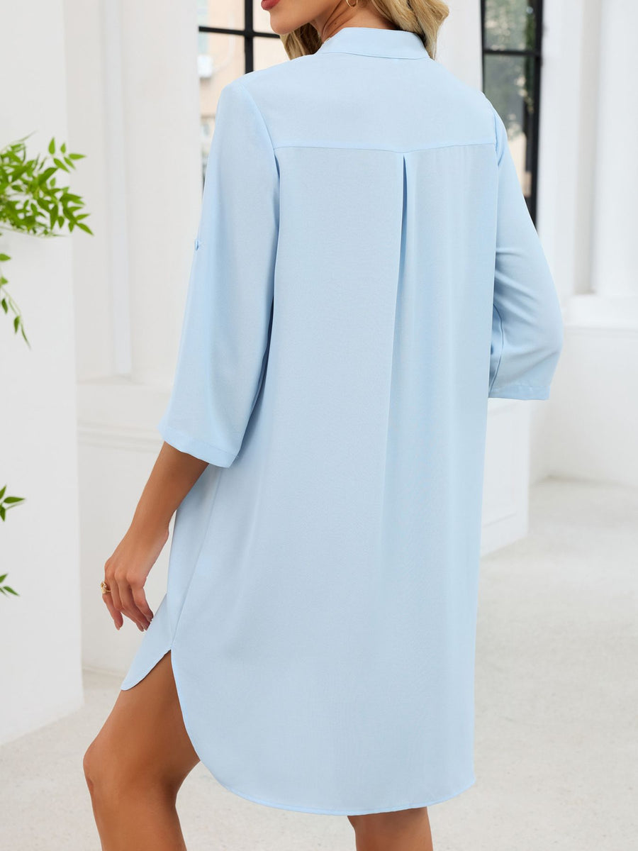 Light blue button-down shirt dress with band collar, 3/4 sleeves, and side slits.
