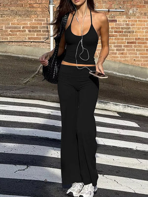 Black halter crop top and wide-leg pants set with a casual vibe.