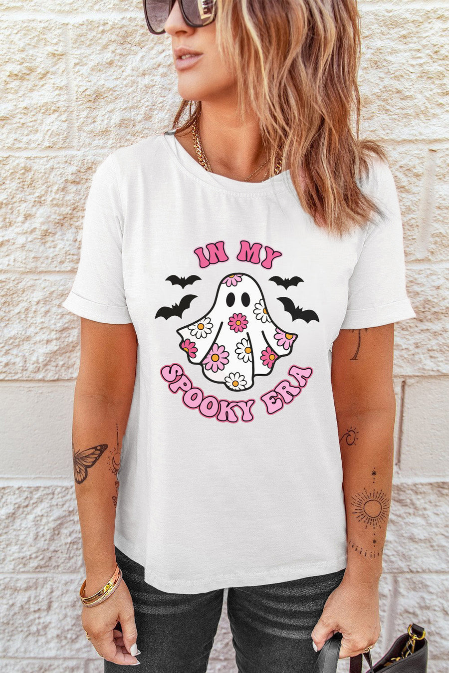 White graphic t-shirt with a floral ghost and bats design that says "In My Spooky Era".