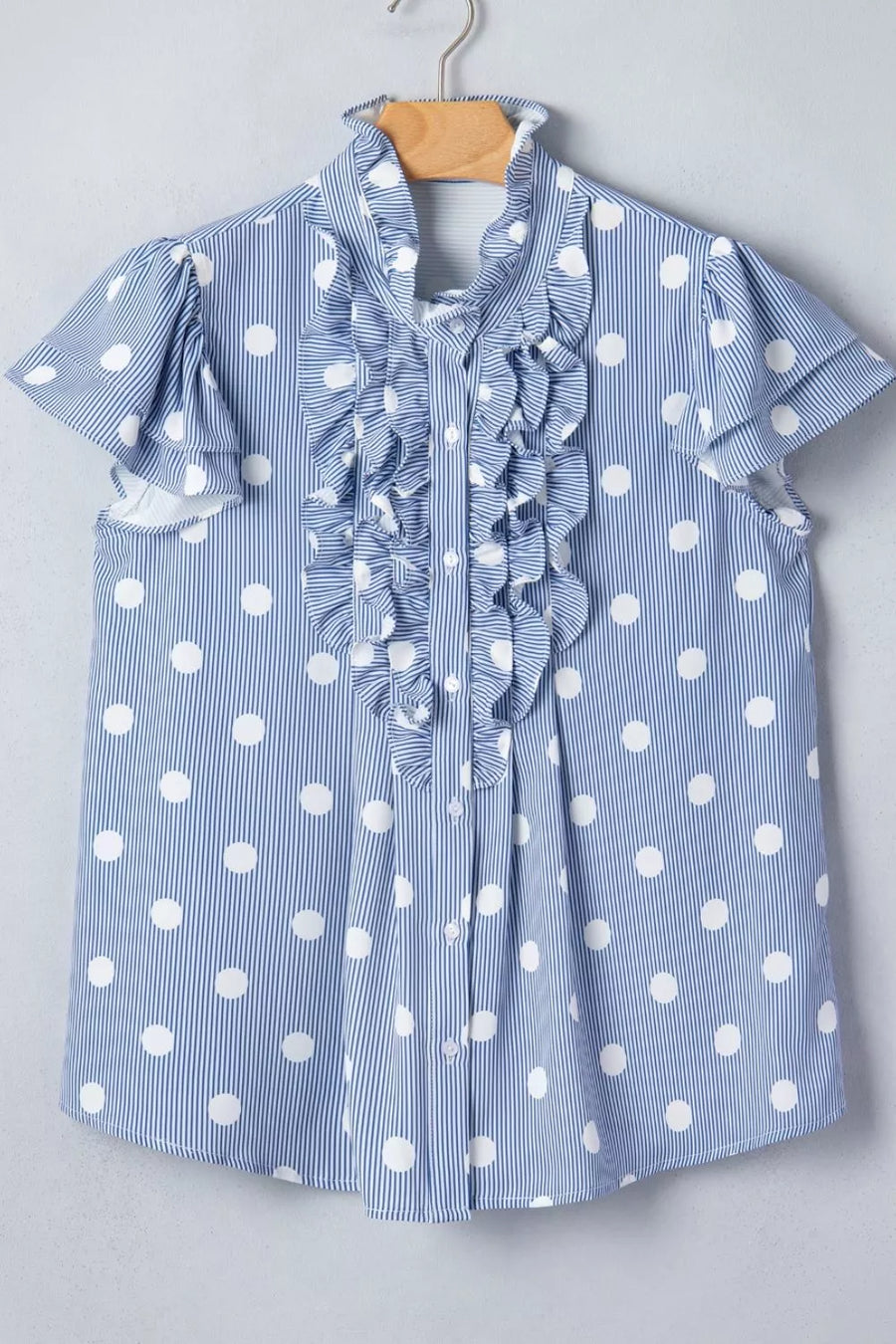 Blue and white polka dot and stripe ruffled shirt with button-down front and short sleeves.