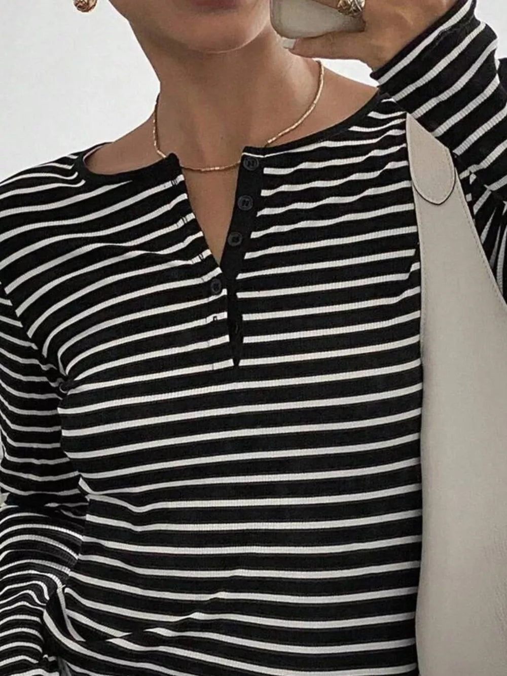 white henley featuring buttoned and striped