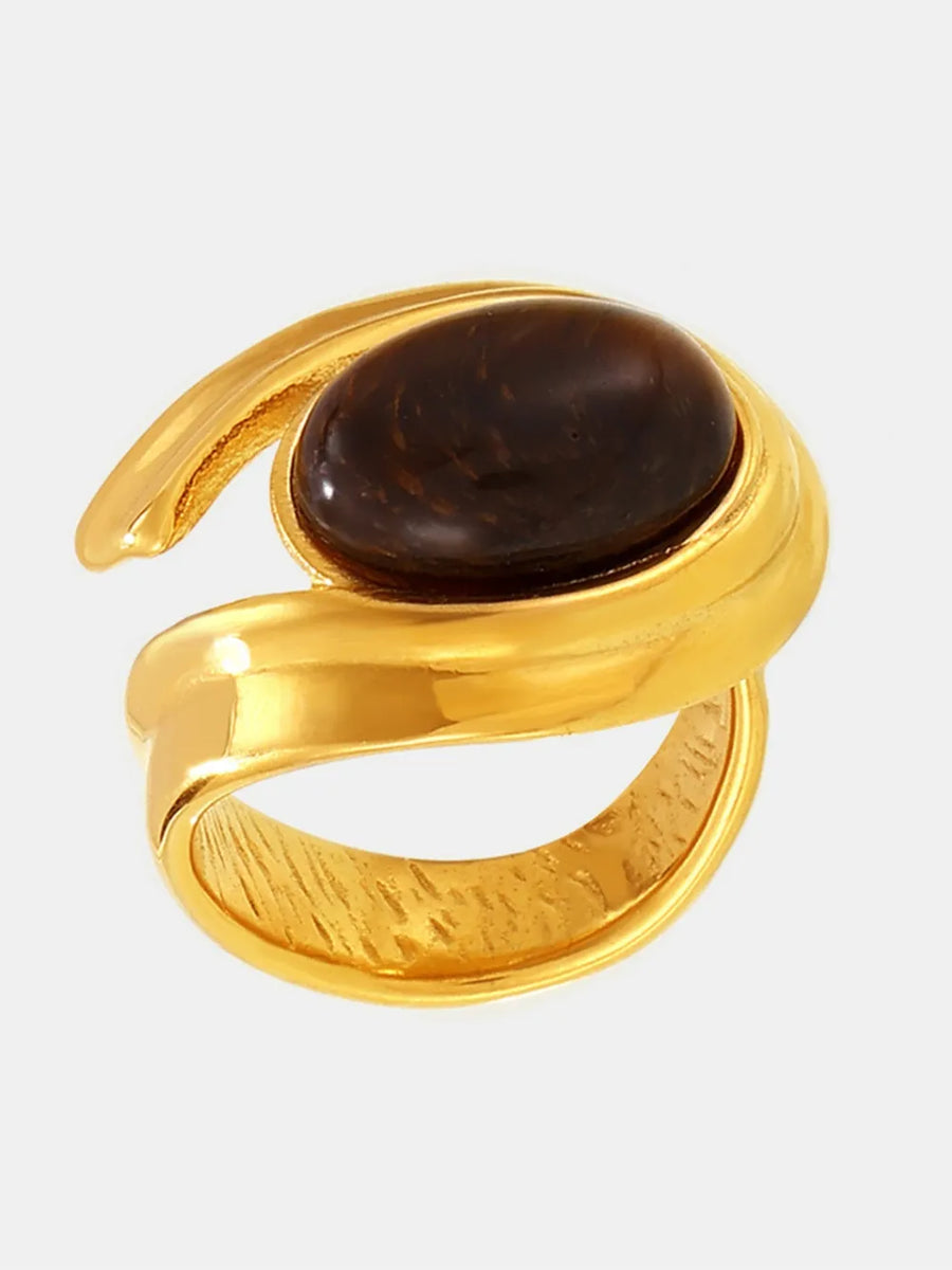 Gold ring with sculptural band and oval tiger's eye stone