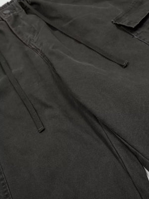 Black cargo pants with drawstring waist and adjustable features.