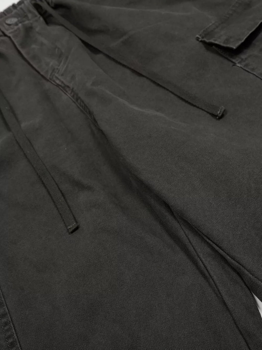 Black cargo pants with drawstring waist and adjustable features.