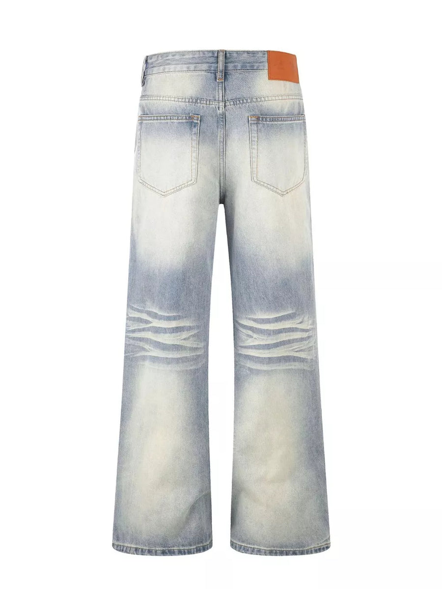 Men's vintage wash wide leg jeans in light blue cotton denim with distressed detailing.