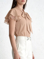 Beige tie-neck blouse with ruffle sleeves and lace trim