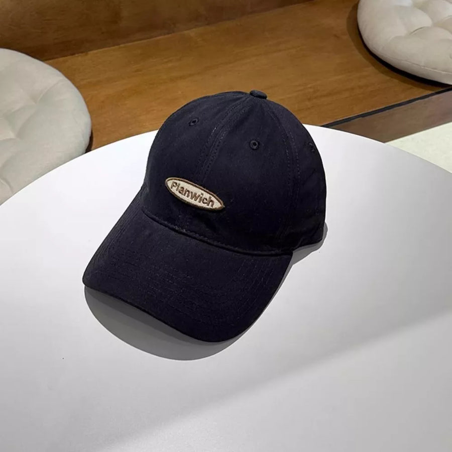 Navy baseball cap with embroidered oval logo patch