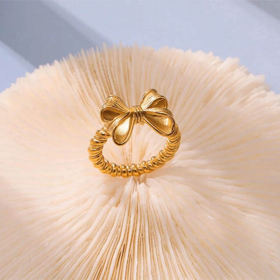 Gold textured bow knot ring with twisted band detail