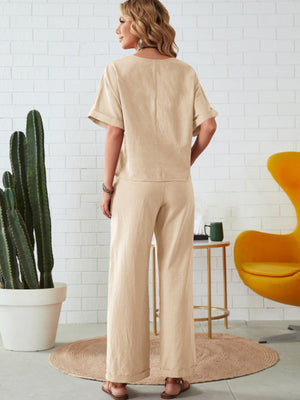 Relaxed linen co-ord set in tan, featuring a wide leg pant and short sleeve top.