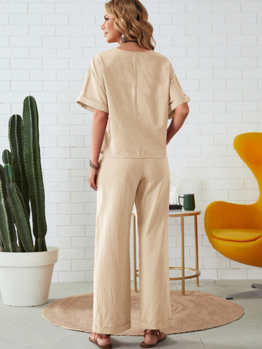 Relaxed linen co-ord set in tan, featuring a wide leg pant and short sleeve top.