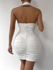 White halter neck ruched mini dress with backless detail and bodycon fit.