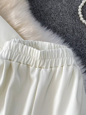 White belted two-piece set with elastic waistband and pockets.